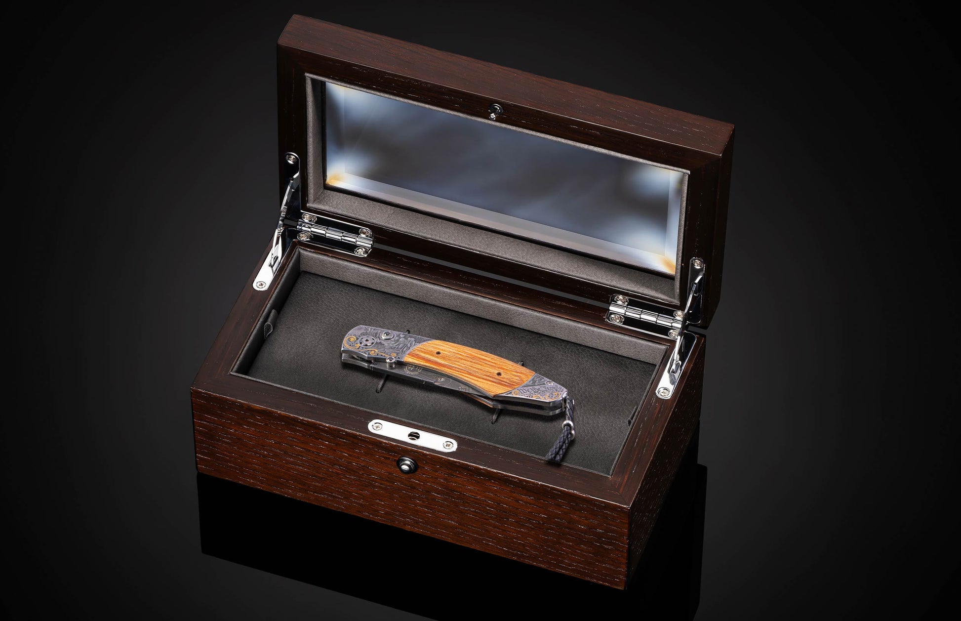 folding knife in wooden display case.
