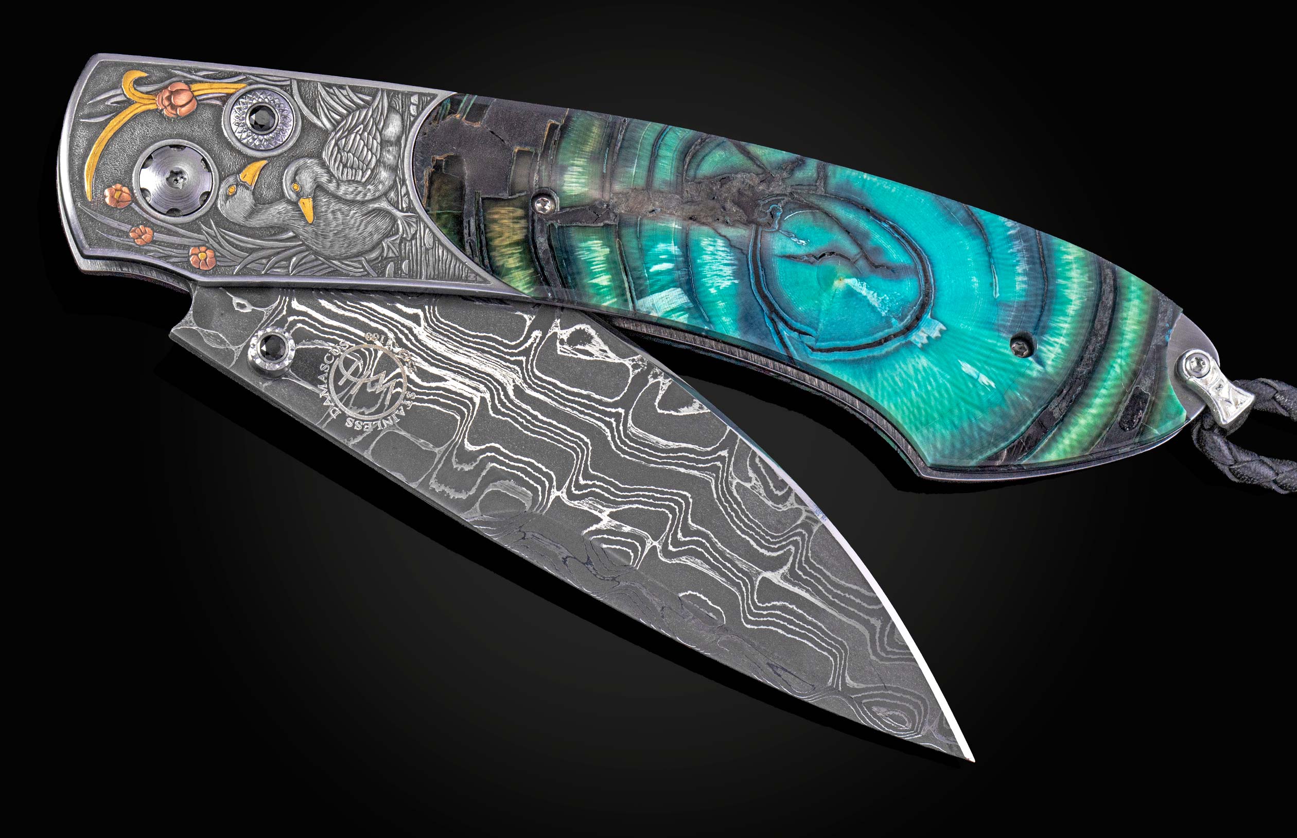 Hand engraved William Henry knife with mammoth tusk handle and damascus blade on a dark background