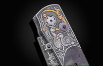 Hand engraved William Henry knife with mammoth tusk handle and damascus blade on a dark background