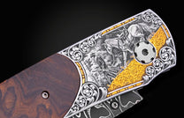 Engraved folding knife with dark wood and silver-toned metal handle, featuring a hunter, horse, and gold wheat scene.