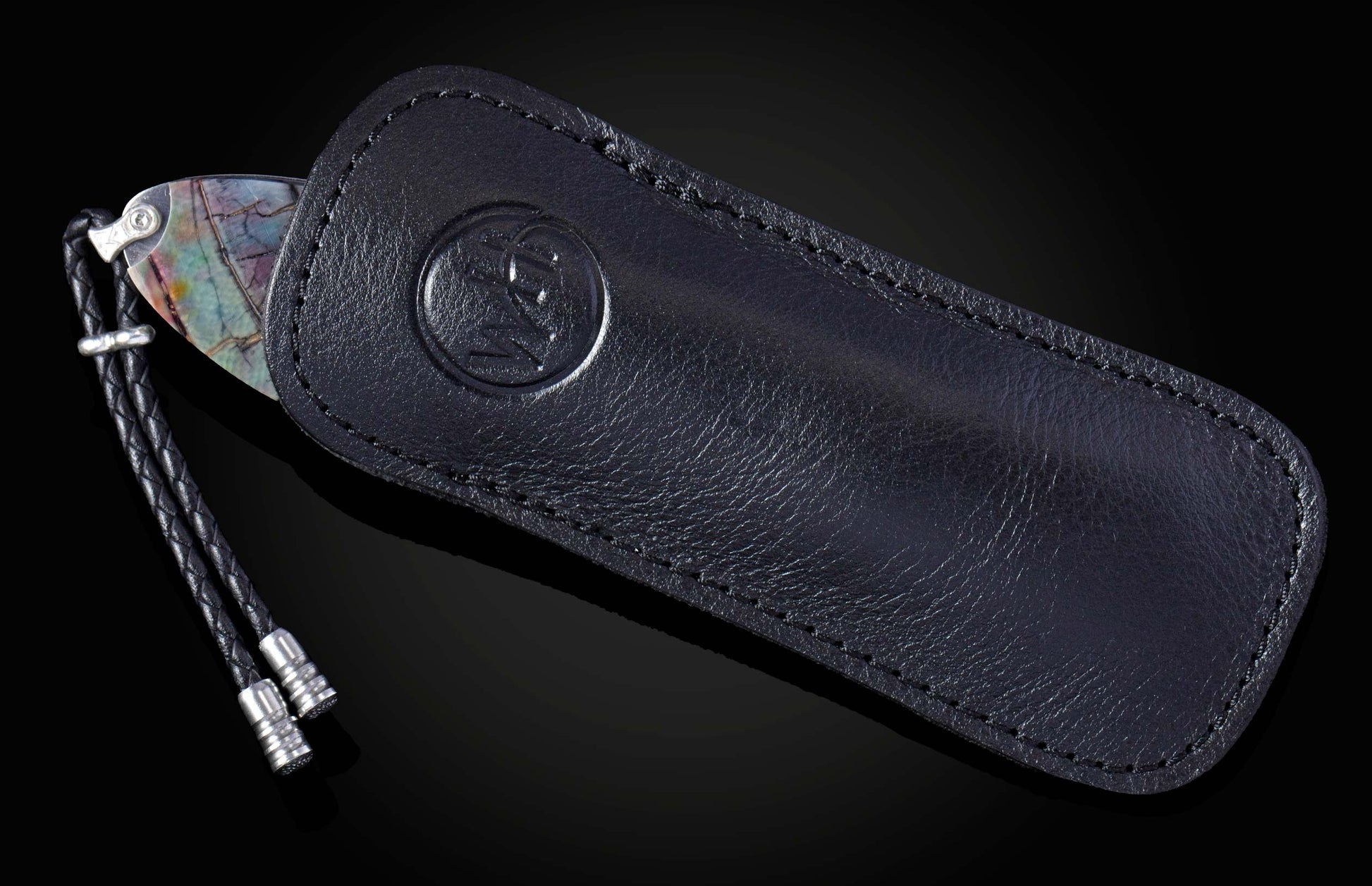 Hand engraved knife with fossil mammoth tusk on a black background