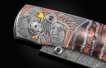 Ornate knife handle engraved with a Native American chief, eagle, and wolf, featuring black gems, a damascus blade, and patterned stone accents.