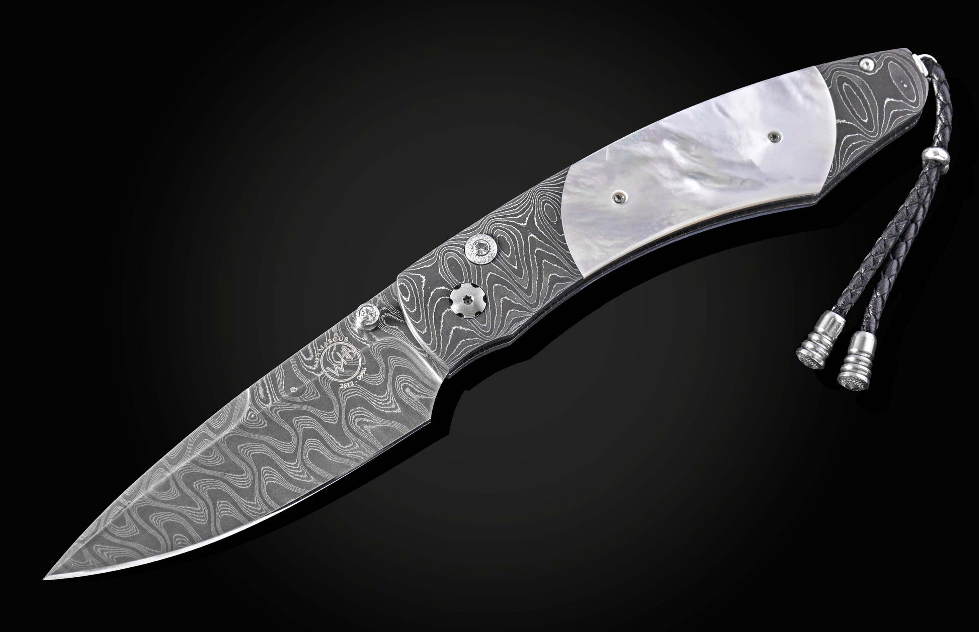 Damascus steel knife with mother-of-pearl inlay and braided lanyard by B12, side view on black background