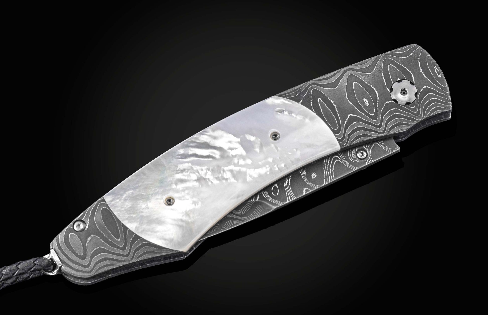Luxury folding knife with mother-of-pearl inlay and damascus steel handle, by B12, side view on black background