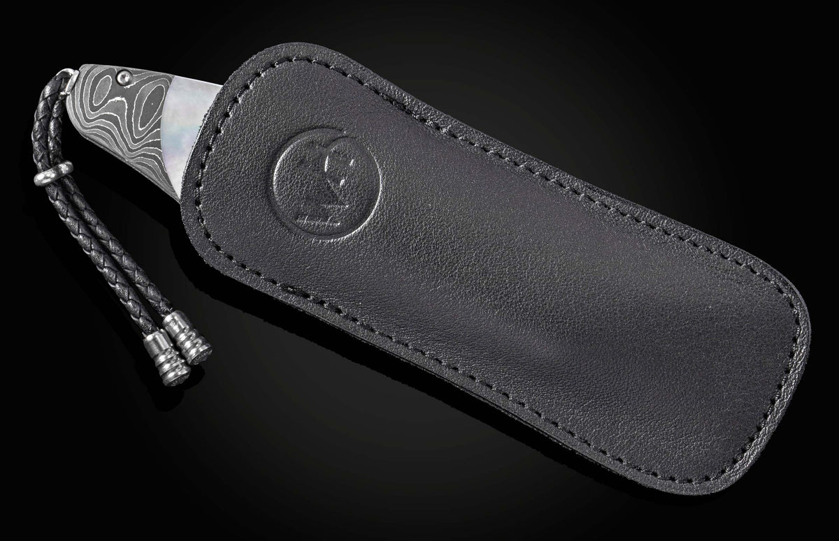 Luxury Damascus steel knife with mother-of-pearl inlay, by B12, in black leather sheath with braided cord and embossed logo, side view