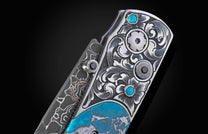 Ornate knife with engraved silver handle, turquoise inlays, black gems, and Damascus pattern details.