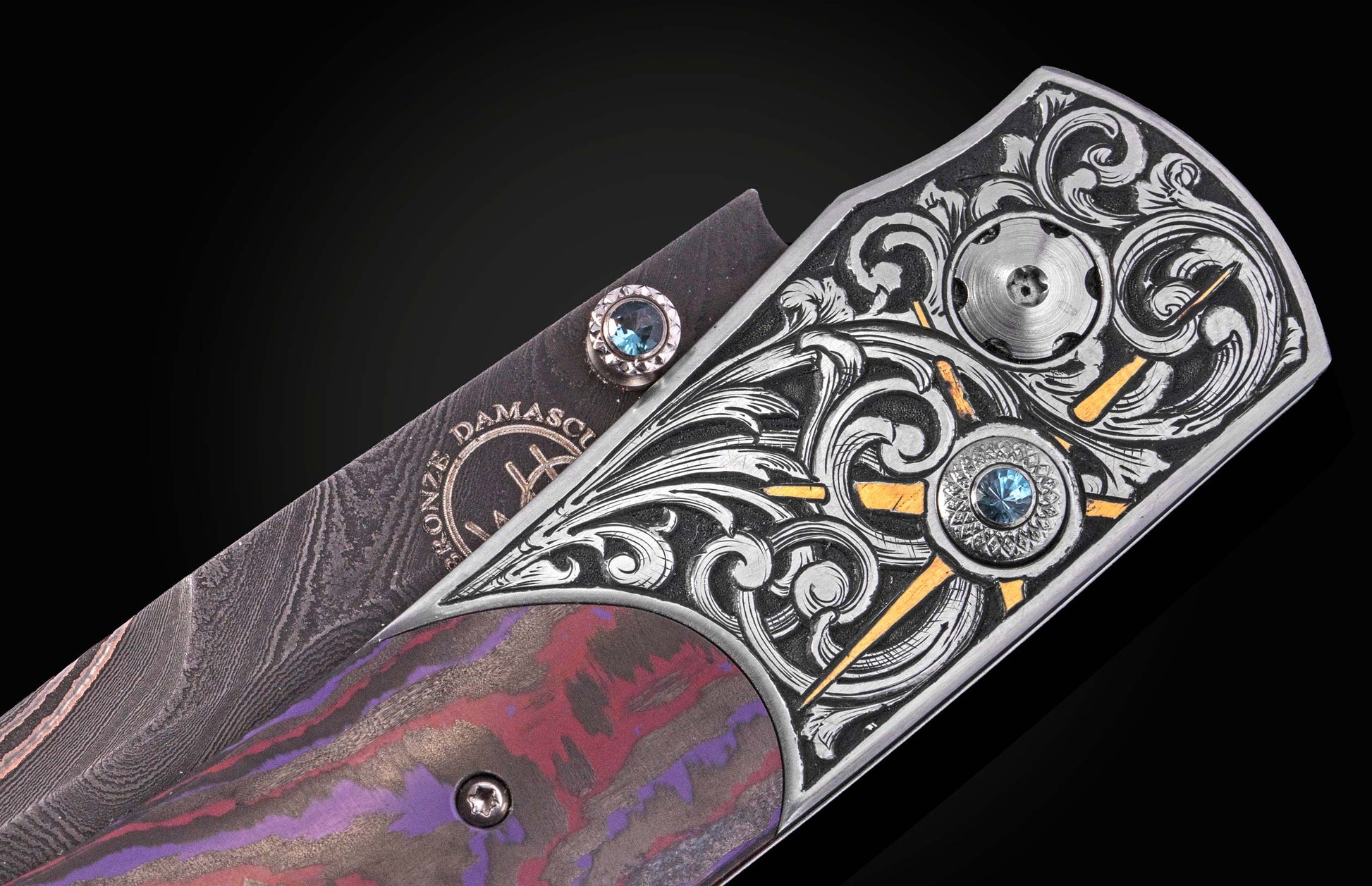Luxury Damascus steel knife with ornate silver filigree, blue gemstones, and marbled red-purple handle, side view.