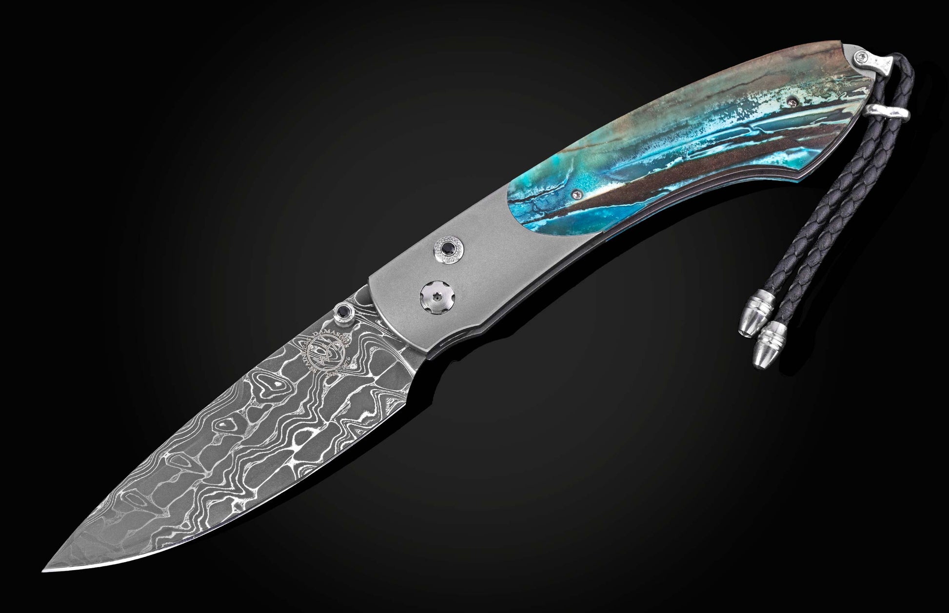 Damascus steel knife with blue resin handle by B12, featuring intricate wave patterns and braided lanyard, side view on black background