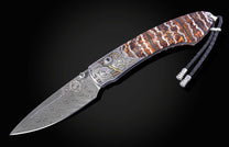 Hand engraved knife depicting pirates with fossil mammoth tooth handle and damascus blade shown open