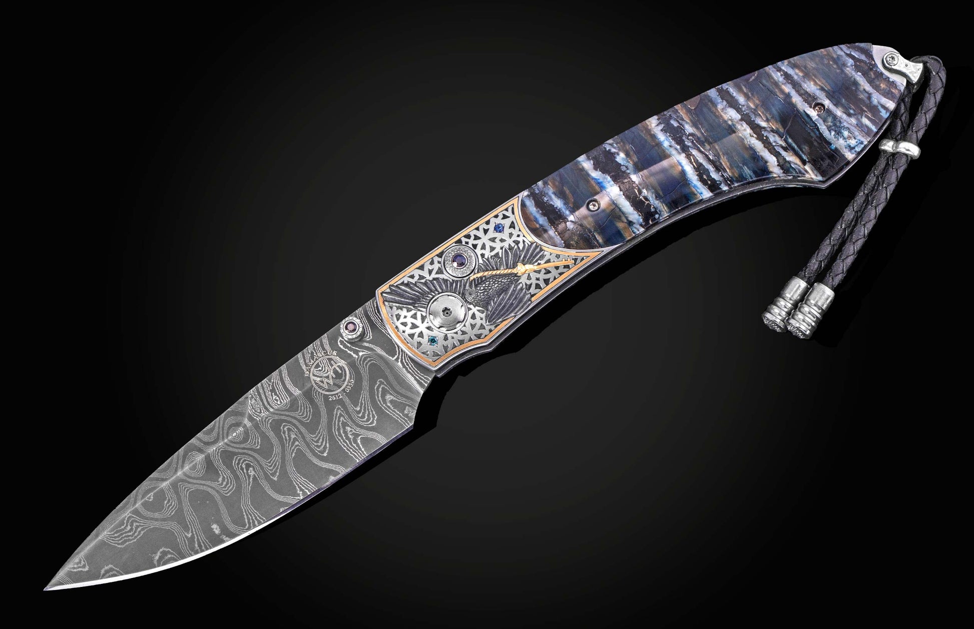 Damascus steel knife with intricate raven inlay and blue gemstones, by B12, featuring marbled handle and braided lanyard, side view on black background