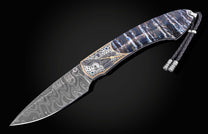 Damascus steel knife with intricate raven inlay and blue gemstones, by B12, featuring marbled handle and braided lanyard, side view on black background