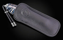 Luxury B12 Raven knife with marbled blue and black handle, by W.K., in black leather sheath with embossed logo and braided cord, side view