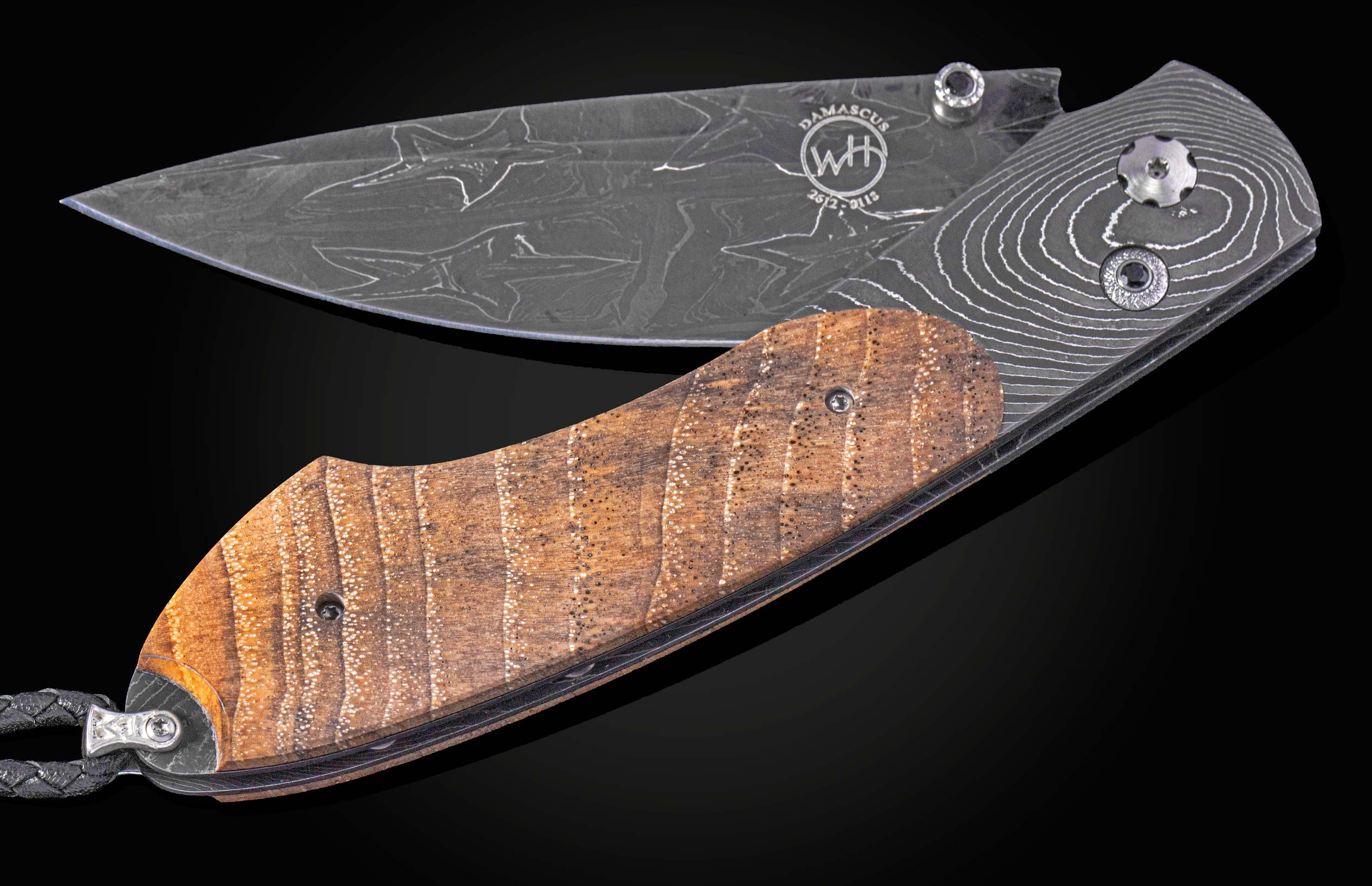 Folding knife with wooden handle and damascus blade on a black background