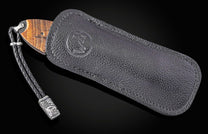 Folding knife with wooden handle and damascus blade on a black background