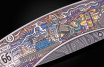 Knife with colorful handle showing Route 66 landmarks like a Ferris wheel and whale, alongside a Damascus steel blade.