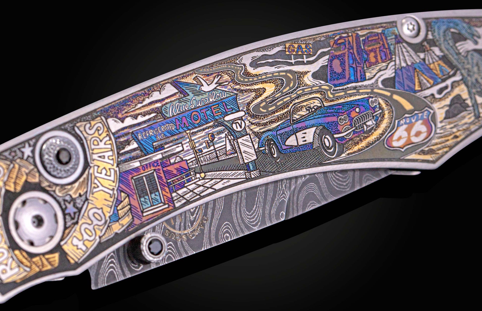 Decorative knife with an intricately engraved, multi-colored Route 66 scene on the handle and a swirling Damascus pattern on the blade.