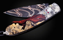 Decorative knife with artistic handle design on a black background