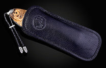 Decorative knife with artistic handle design on a black background