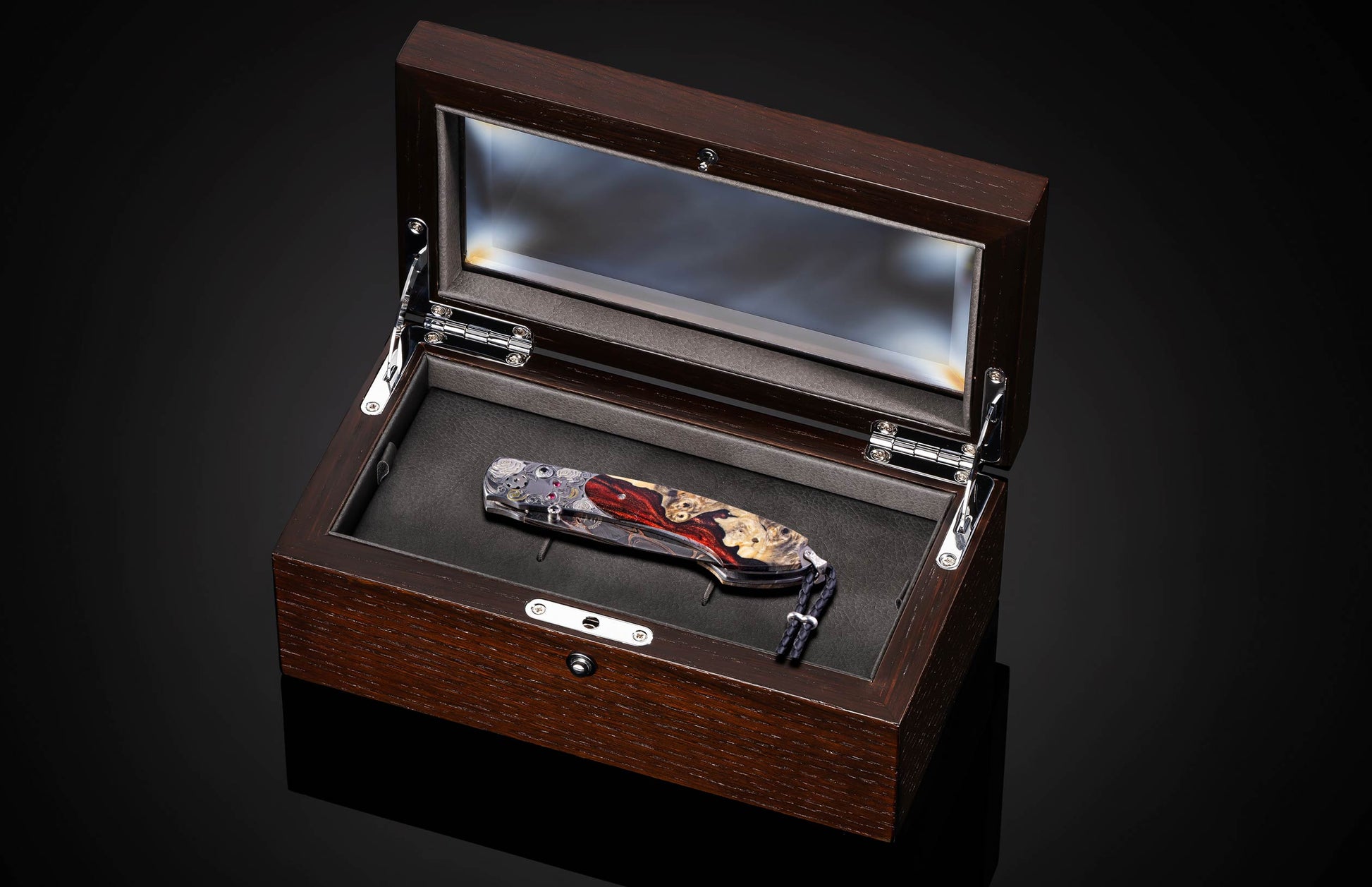 Decorative knife with artistic handle design on a black background