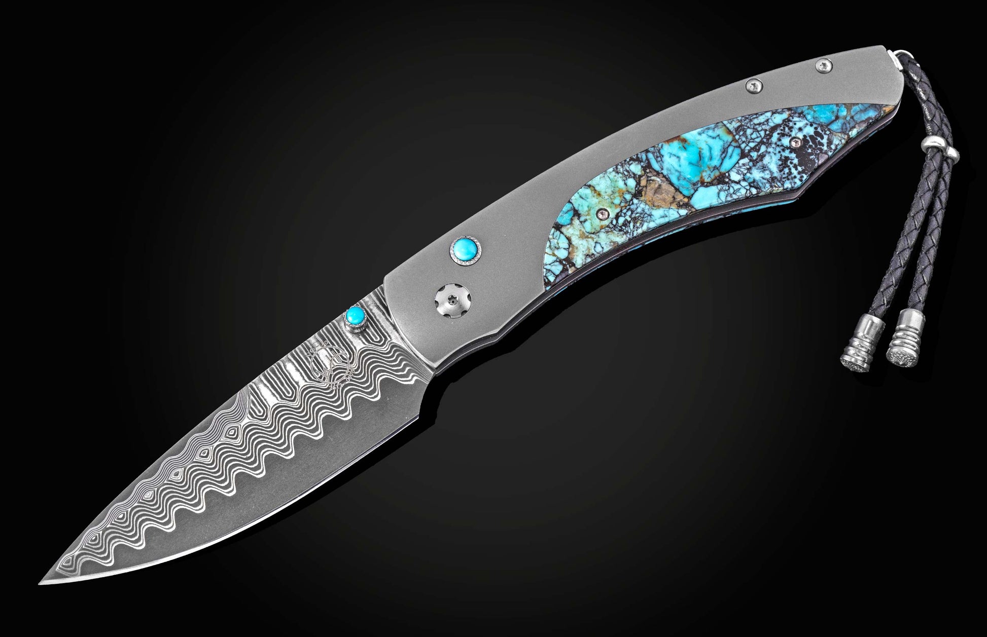 Luxury folding knife with damascus steel blade and turquoise inlay handle, by B12, featuring wave pattern and braided lanyard, side view on black background