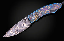 Color laser engraved William Henry Knife with damascus steel blade showing sea life