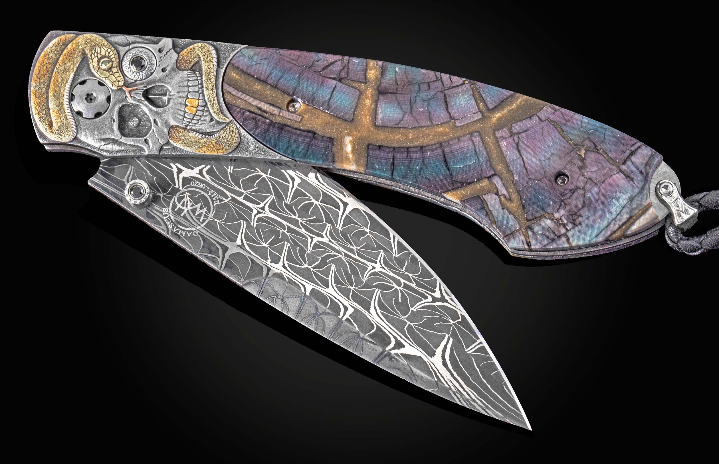 Decorative folding knife with intricate design on a dark background