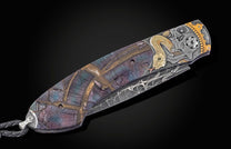 Decorative pocket knife with intricate designs on a black background