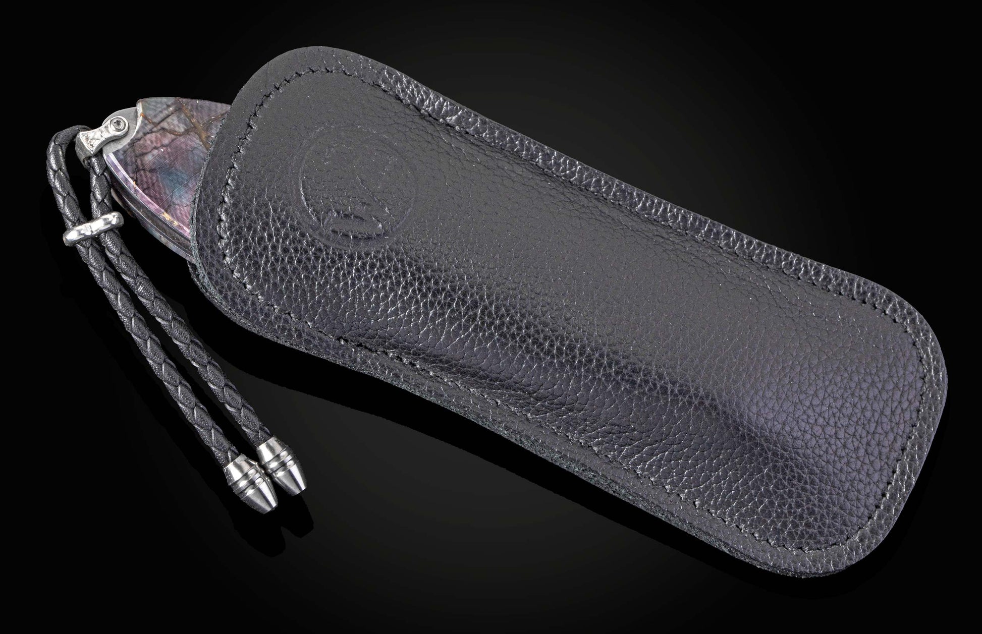 Black leather case with a strap on a black background