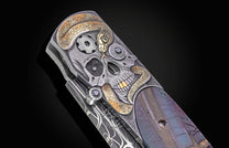 Decorative knife with skull and snake design on a dark background