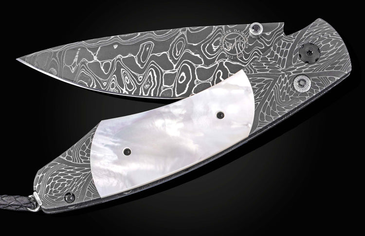 Damascus steel folding knife with wavy pattern and mother-of-pearl inlay, by William Henry, side view on black background
