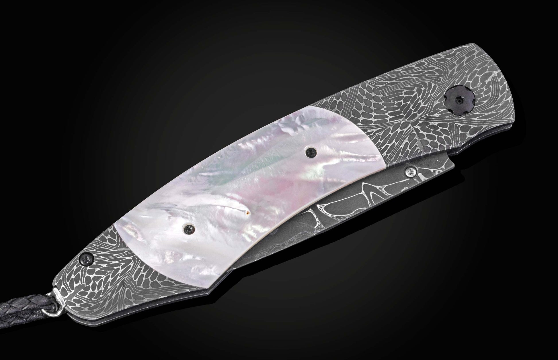Silver folding knife with damascus steel handle and mother-of-pearl inlay, side view on black background