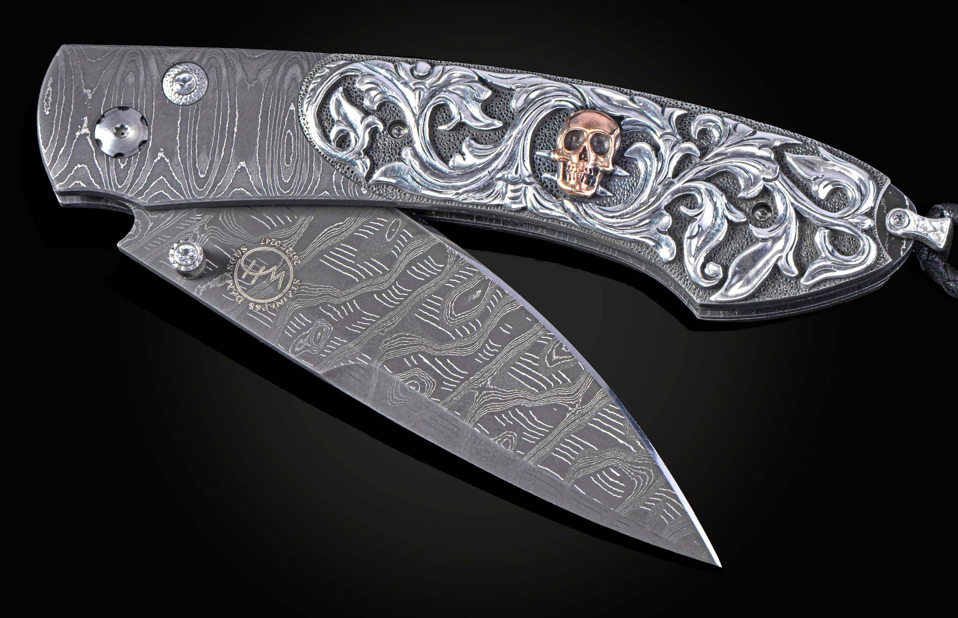 Hand carved silver folding knife with damascus steel on a black background
