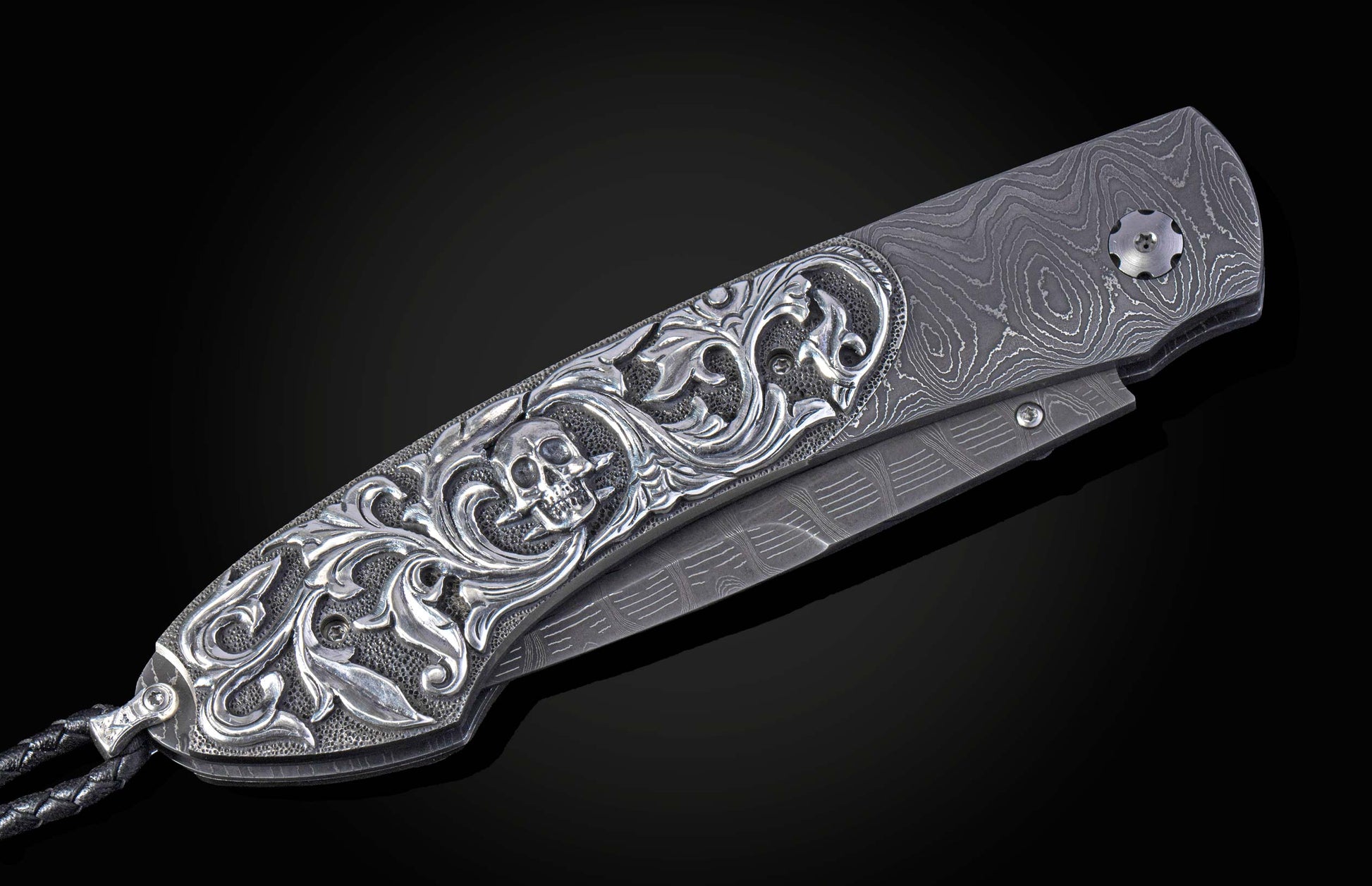 Hand carved silver folding knife with damascus steel on a black background