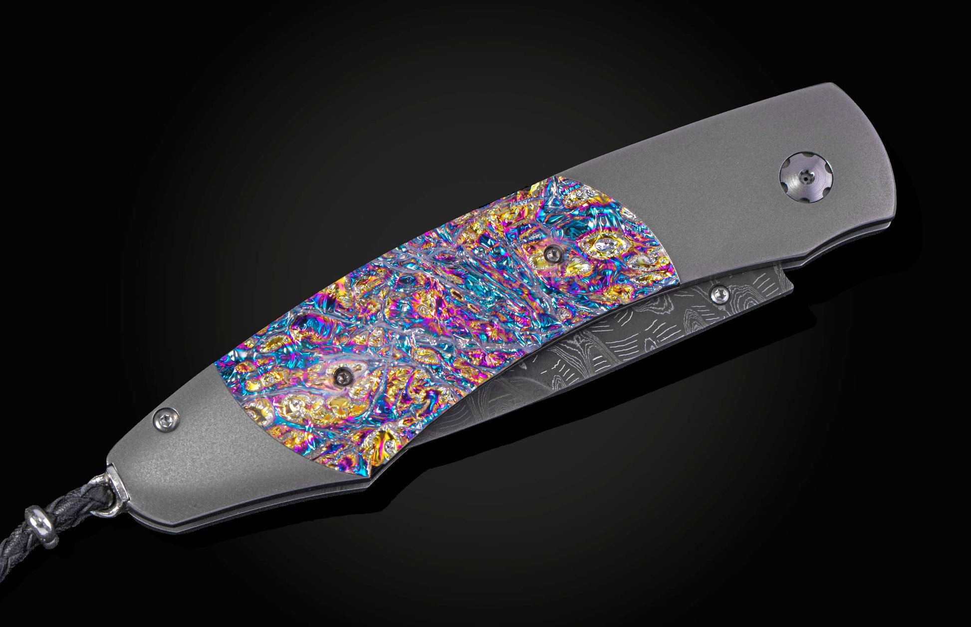 Decorative knife with colorful handle and damascus blade on a black background