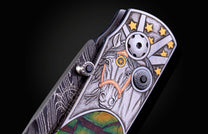 Ornate knife handle with an engraved silver horse head, gold stars, Damascus steel, a black gemstone, and colorful inlay.