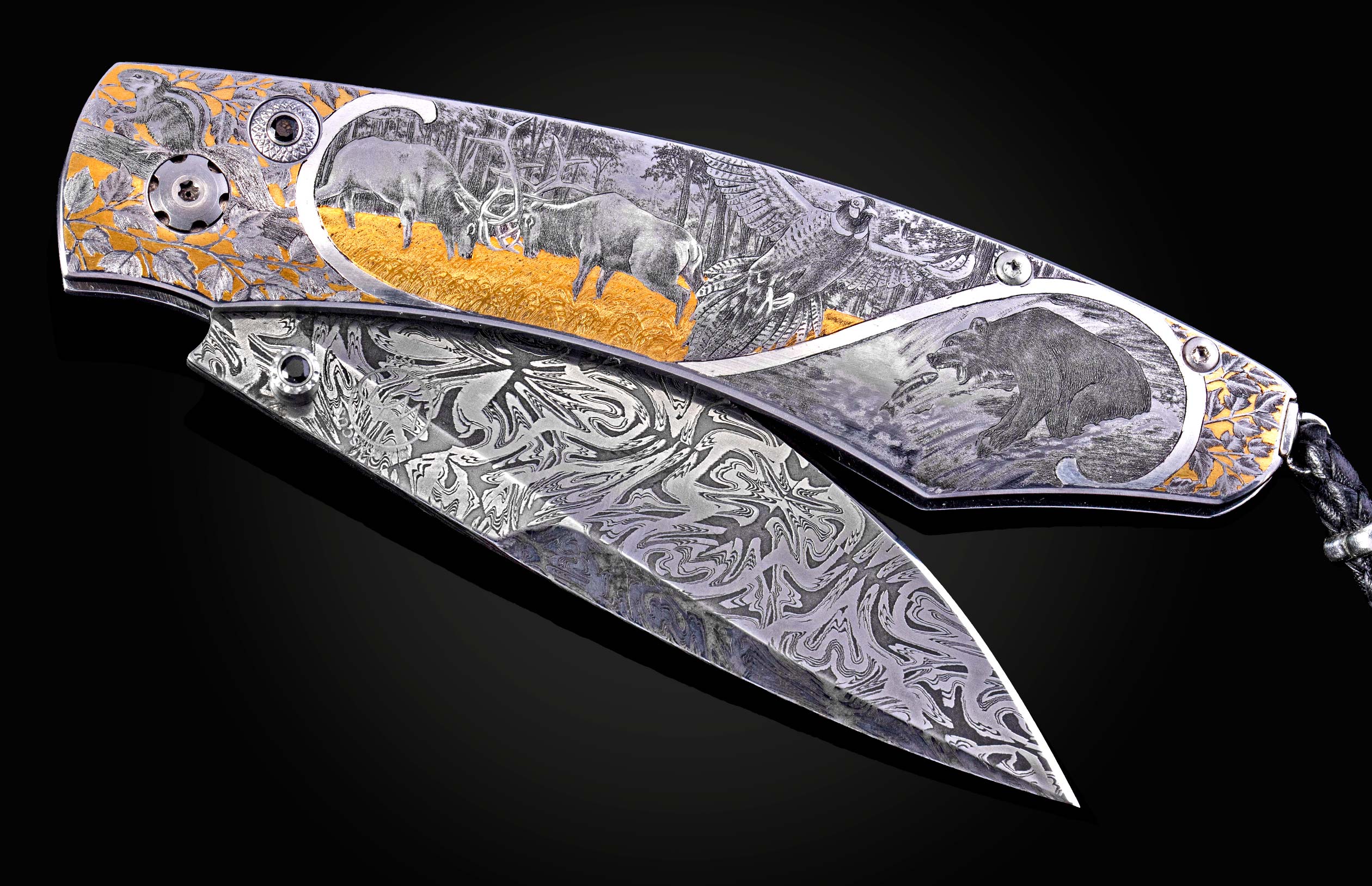 Engraved folding knife with silver-toned handle detailed with gold accents and wildlife scenes, paired with a patterned Damascus steel blade.