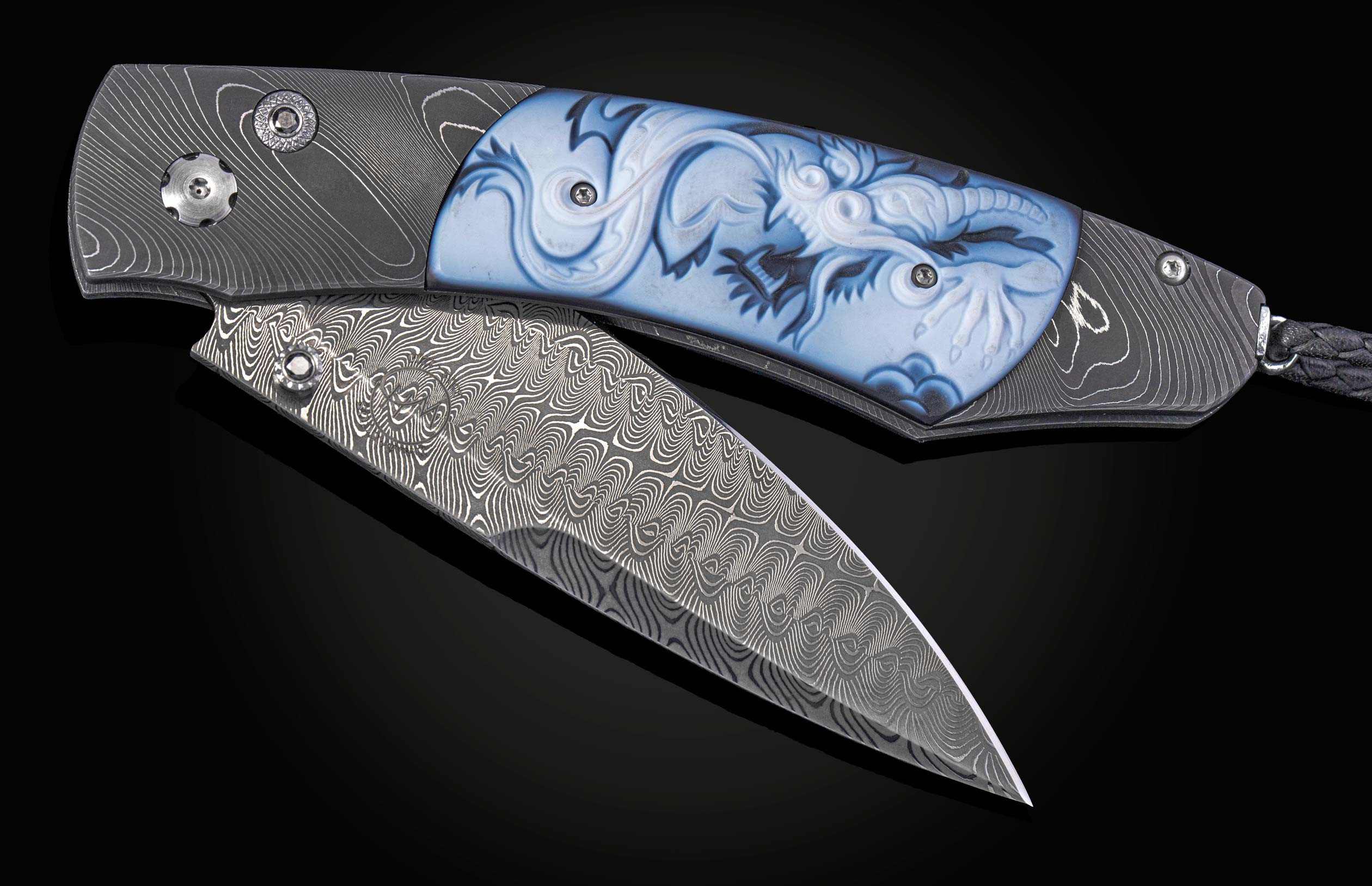 Folding knife with damascus blade and carved agate handle on a black background