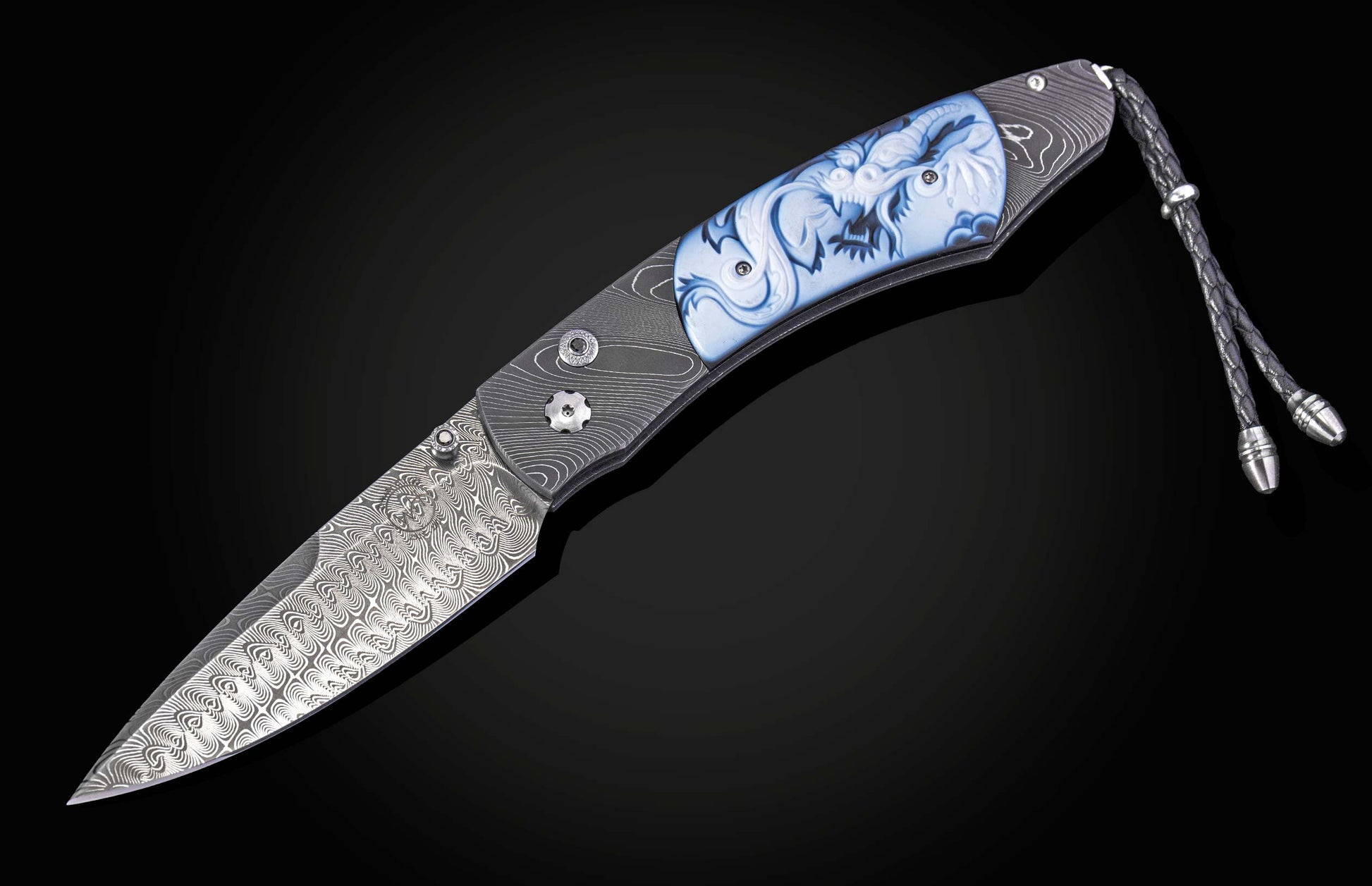 Folding knife with damascus blade and carved agate handle on a black background