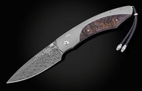 Folding knife with Damascus patterned blade and titanium handle featuring a textured fossil inlay, complete with a braided black lanyard.