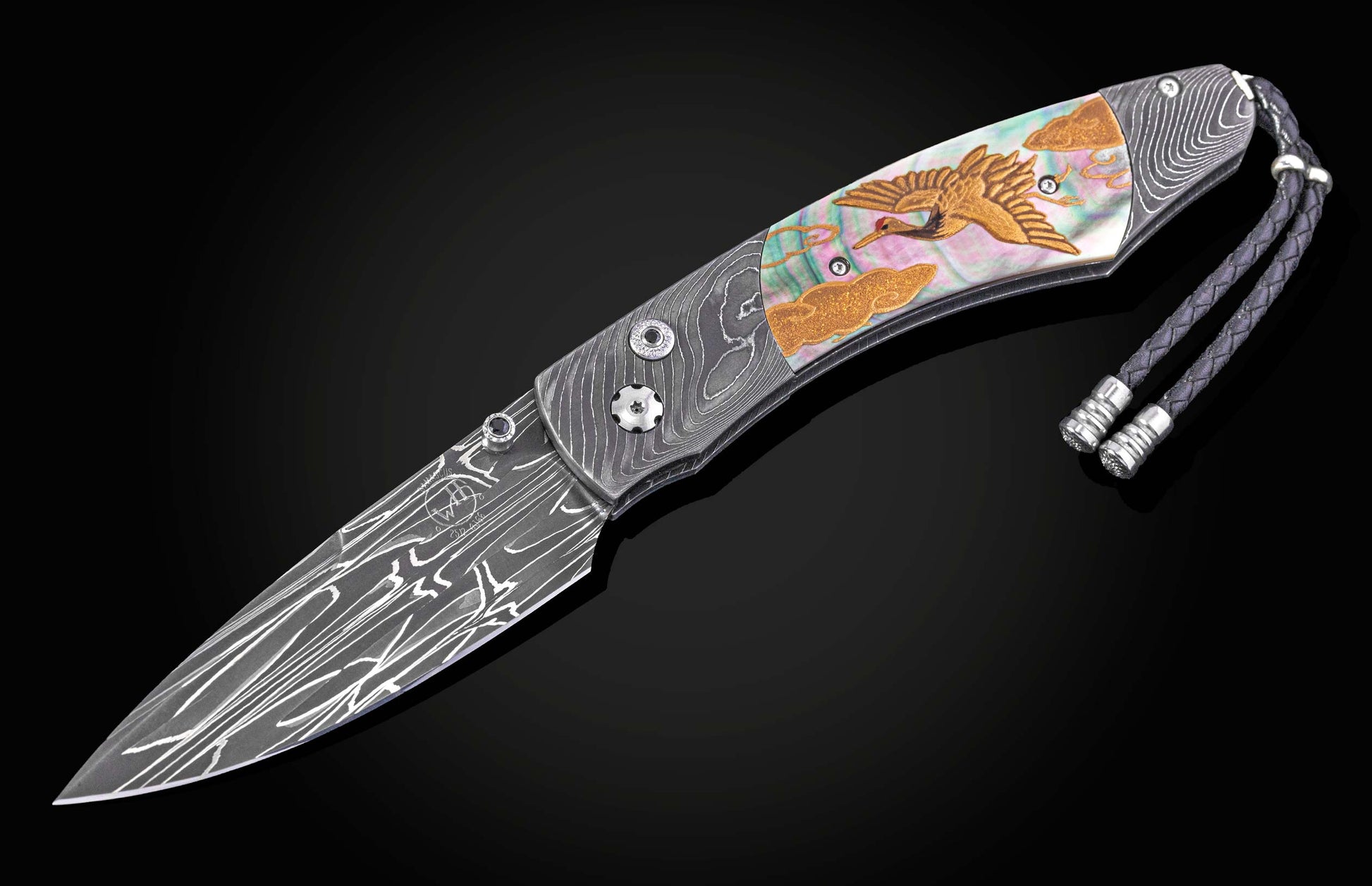 Decorative folding knife with artistic blade and embellishments on a dark background