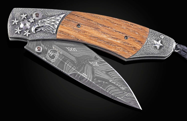 Folding knife with wooden handle and decorative blade on a black background