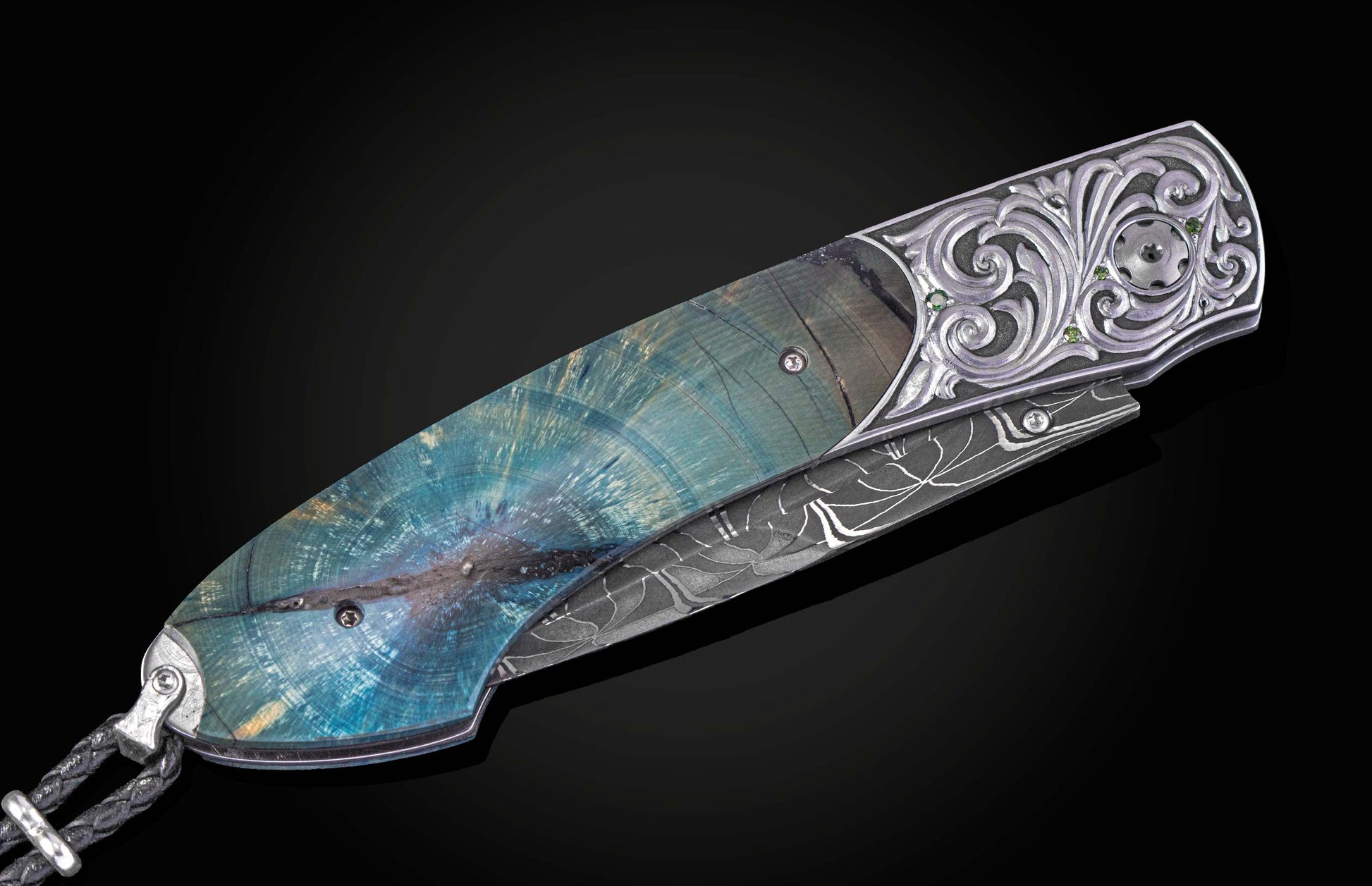 Decorative knife with damascus blade and fossilized woolly mammoth tusk scales on a black background