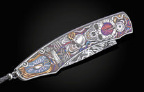 Decorative knife with intricate designs on a black background