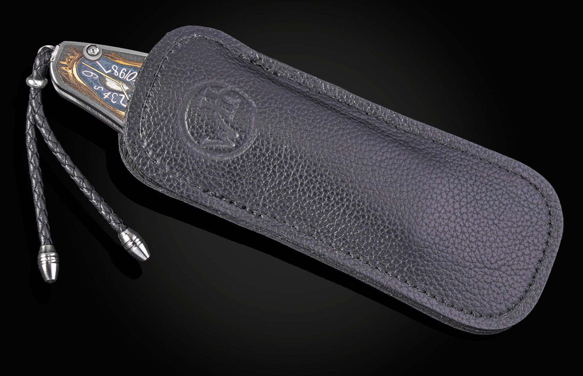 Decorative knife with intricate designs on a black background