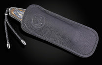 Decorative knife with intricate designs on a black background