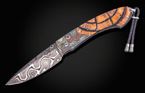 William Henry knife with woolly mammoth tusk, hand engraving, and damascus steel blade.