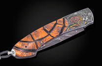 William Henry knife with woolly mammoth tusk, hand engraving, and damascus steel blade.
