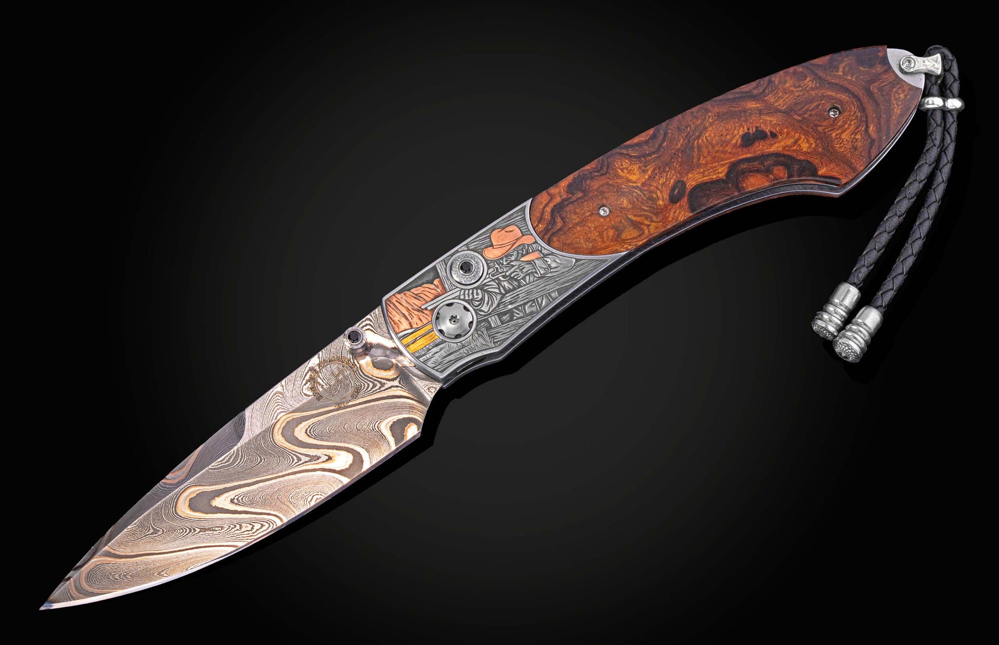 Custom folding knife with a dark burlwood handle, engraved Western-themed bolster, swirling Damascus steel blade, and a black leather lanyard.