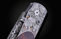 Folding knife with Damascus steel blade , hand engraving, and desert ironwood handle on a black background