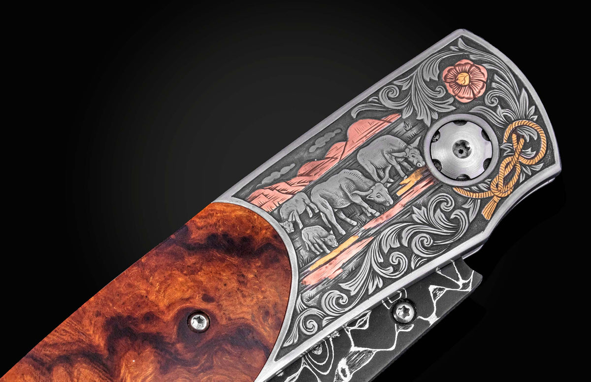 Luxury B12 Wrangler knife with hand-engraved silver bolster featuring cattle scene, floral motifs, and copper accents, paired with rich burl wood handle, side view.